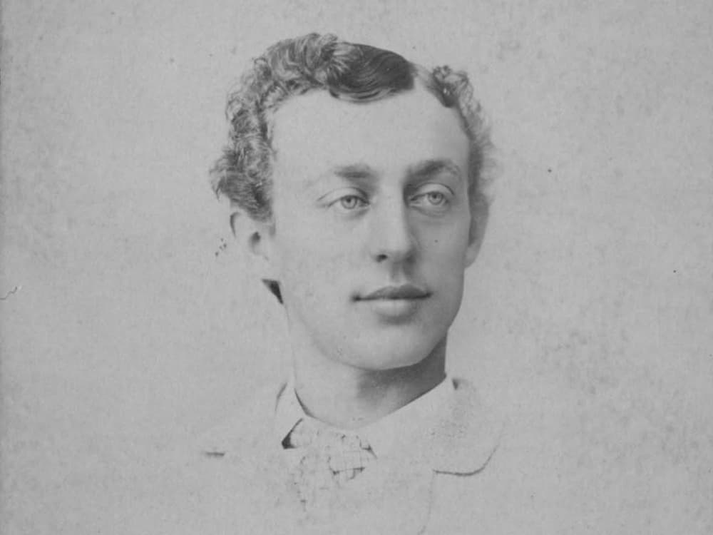 A faded black and white photo of William H. Donner as a young man wearing a jacket and tie.